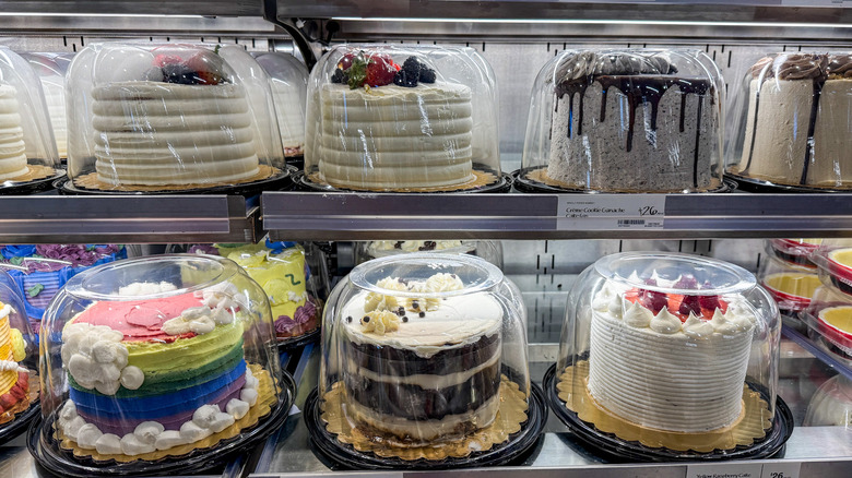 Whole cakes in grocery store pastry case