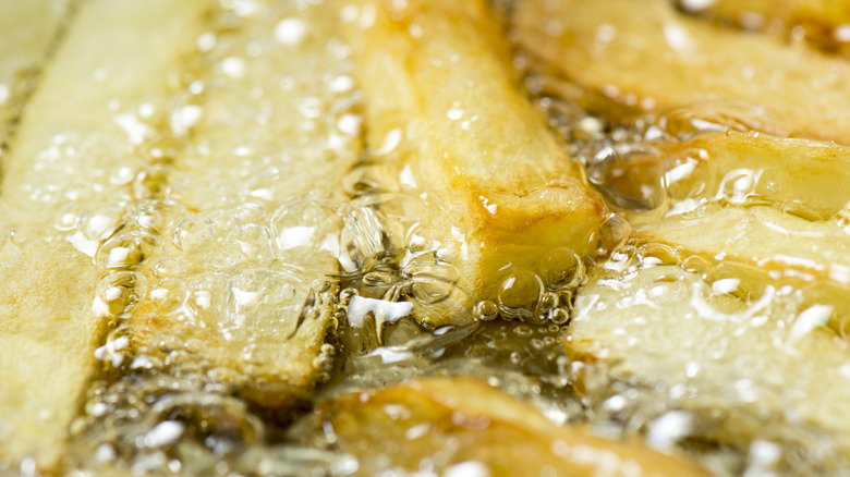 Closeup of fries frying in oil