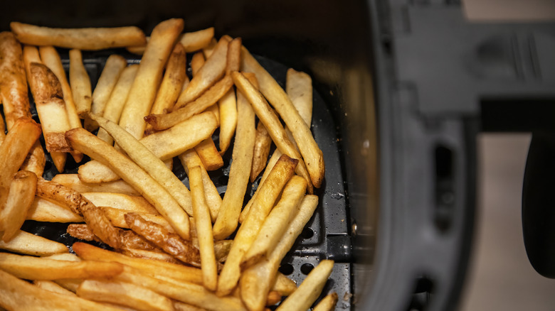 Golden fries in an air fryer basket