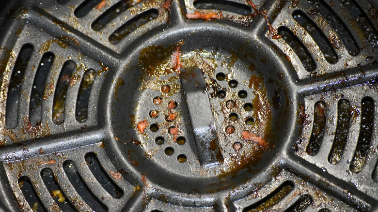 Close up of a dirty air fryer interior