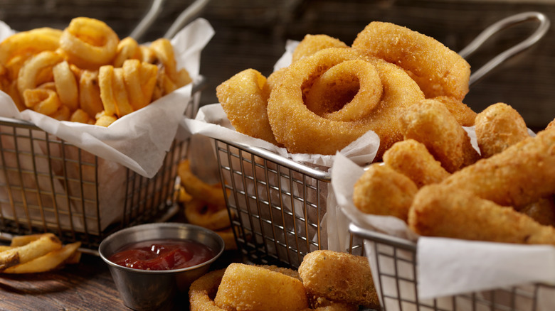 Baskets of onion rings and other fried foods