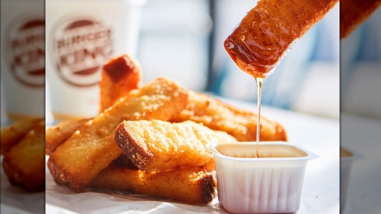 Burger King French toast is shown in a cardboard sleeve.