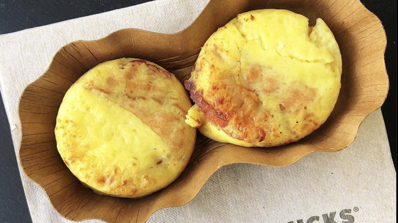 Two Starbucks egg bites are packaged in a container.