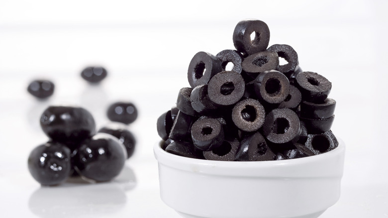 Chopped black olives in a white bowl