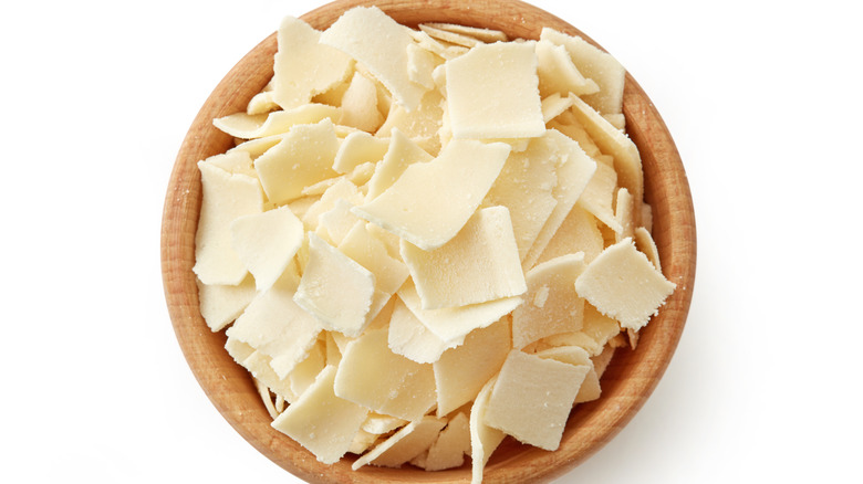 Parmesan shavings in a wooden bowl