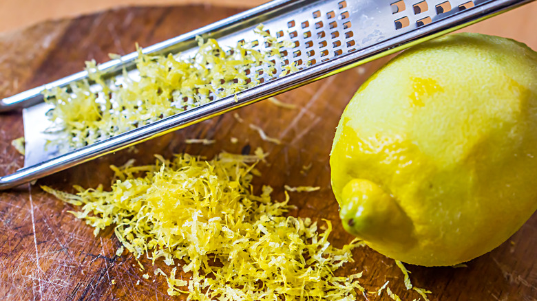 Grated lemon zest on a wooden board