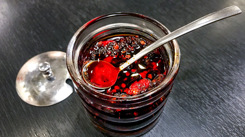 open jar of chile oil with spoon