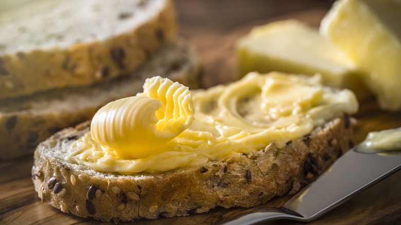 Buttered bread on wooden table