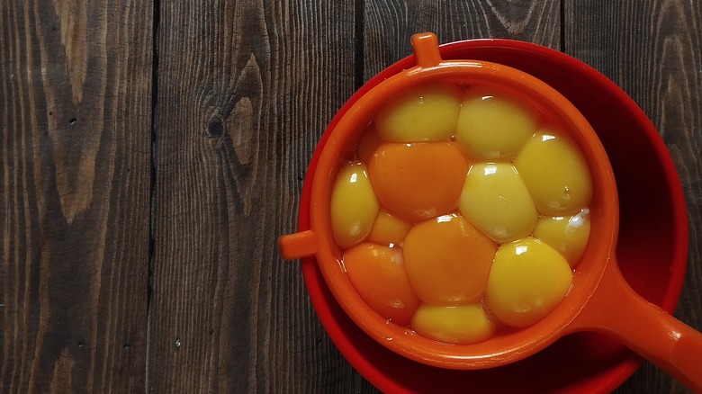 raw eggs in strainer