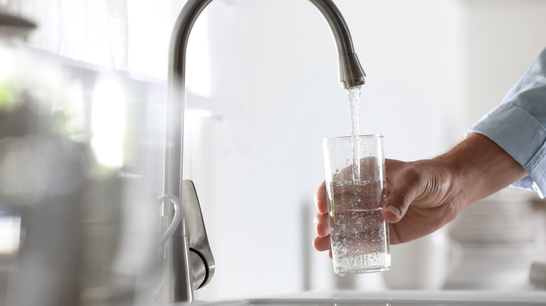 Tap water filling a glass