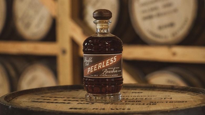 bottle of Kentucky Peerless bourbon on barrell