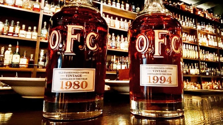 bottles of OFC bourbon on bar top