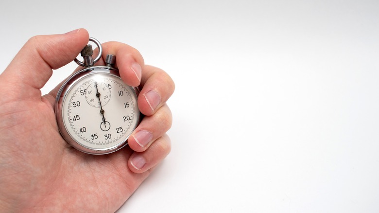 Hand holding a stopwatch