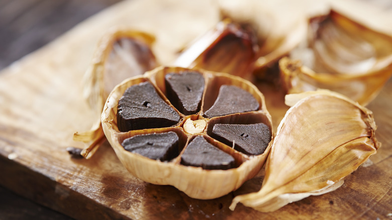 peeled black garlic on board