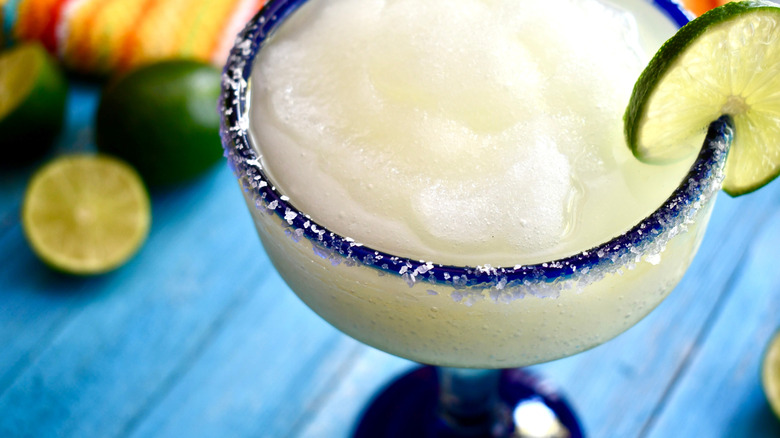 Close-up of a frozen margarita in a blue rim glass