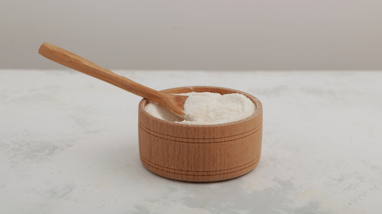 Xanthan gum powder in a wooden bowl