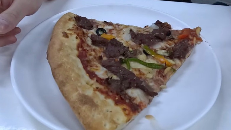 A slice of Costco Korea bulgogi pizza on white plate