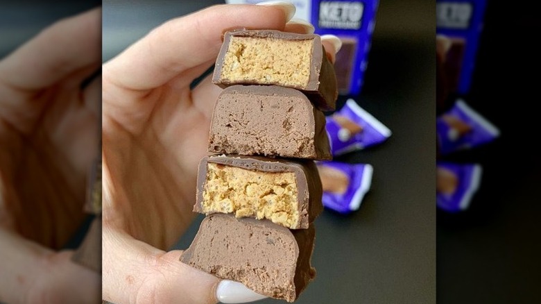 Person holding think! keto bars