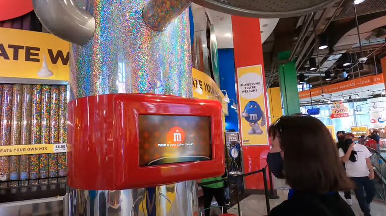 Woman interacting with M&M'S World mood analyzer