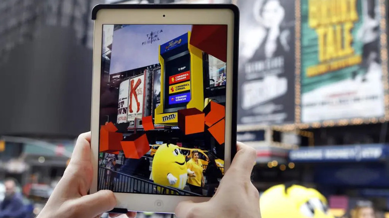 Person using iPad to play M&M's ARcade game