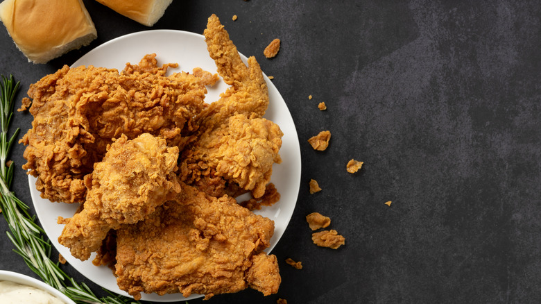 Fried chicken on a plate and black table