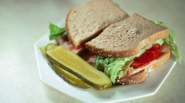 Sandwich and pickles on a white plate