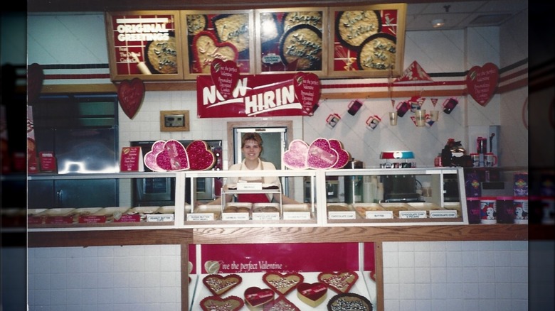 Photo of an employee behind the counter of The Original Cookie Company