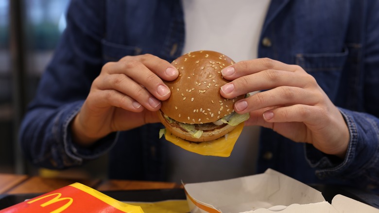 Hands holding McDonald's burger