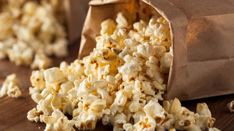 popcorn spilling out of paper bag