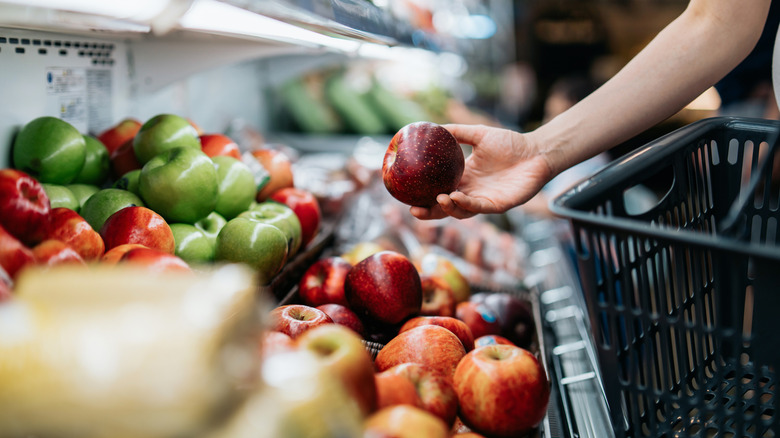 Person shopping for apples