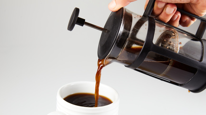 Person pouring coffee from French press