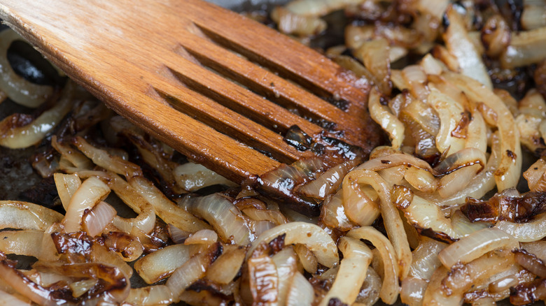 Wooden spatula with caramelized onions 