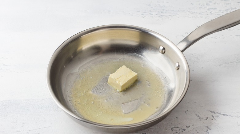 Butter melted in frying pan 