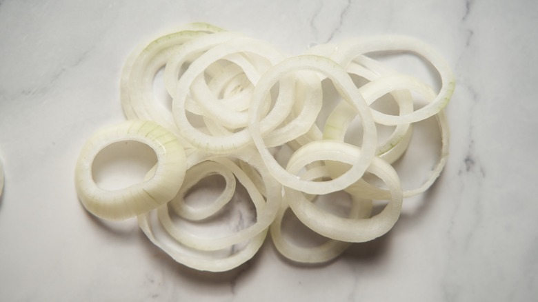 Onions sliced into rings on marble