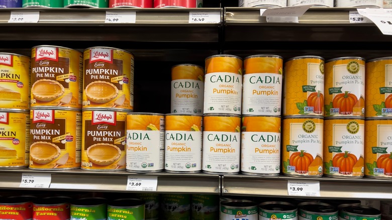 Row of canned pumpkin brands on store shelf