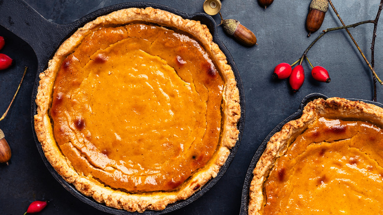 Overbaked pumpkin pies with cracks and burnt spots in filling