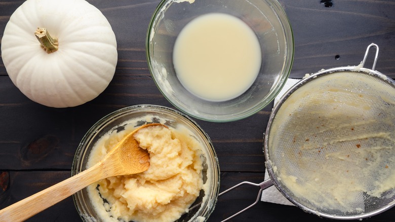 Strained white pumpkin puree by a white pumpkin