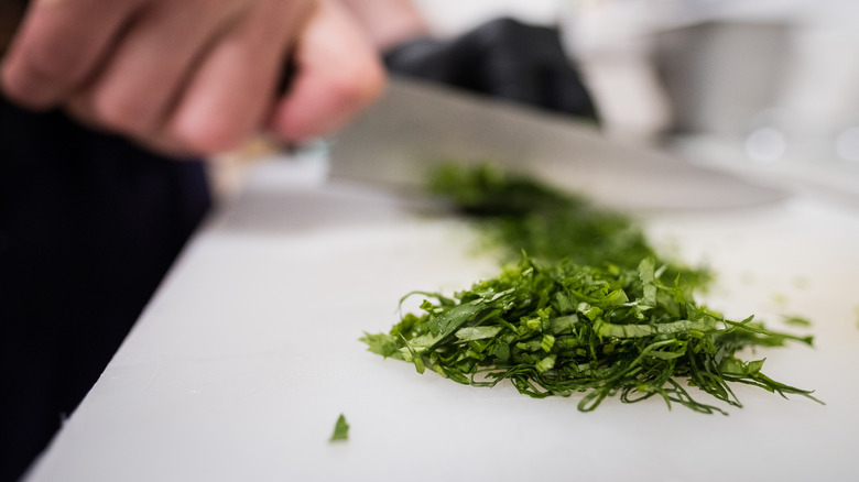 Hand chopping fresh herbs