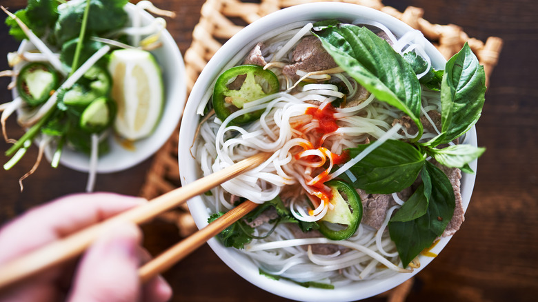 Bowl of pho with garnishes