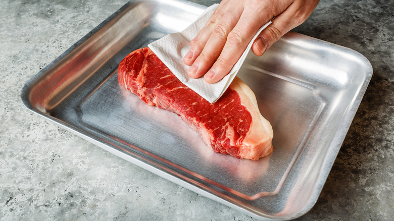 blotting steak dry