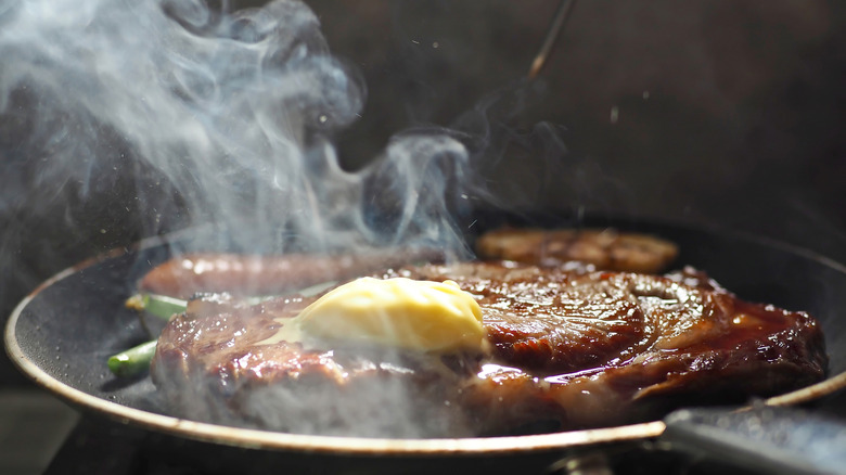 sizzling steak with butter