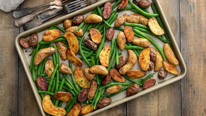 Sheet pan of vegetables on wood