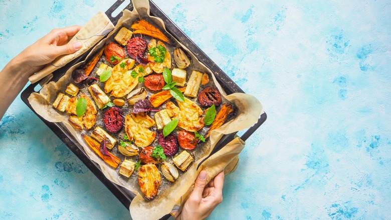 Hands holding sheet pan 