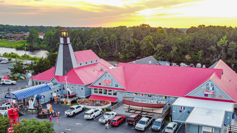 Aerial view of the Original Benjamin's Calabash Seafood restaurant and parking lot with greenery