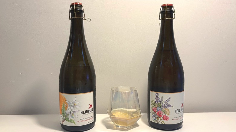 Two bottles and one glass on Heidrun mead on a table