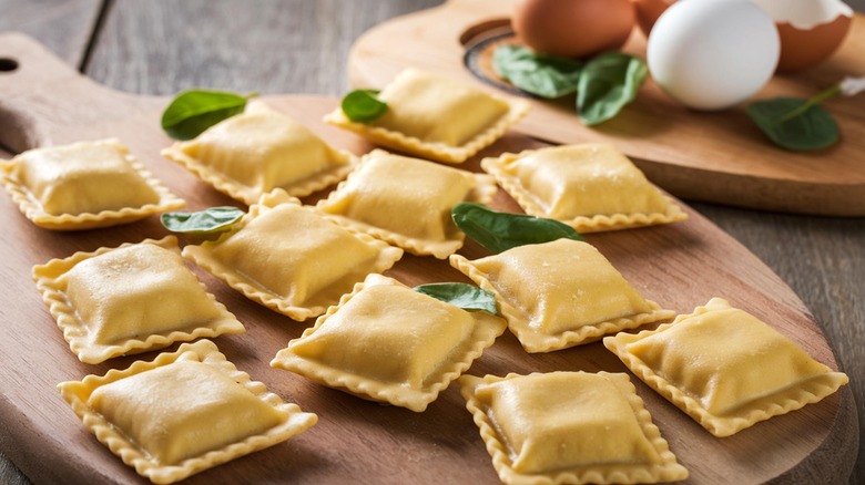 Fresh ravioli on wooden board