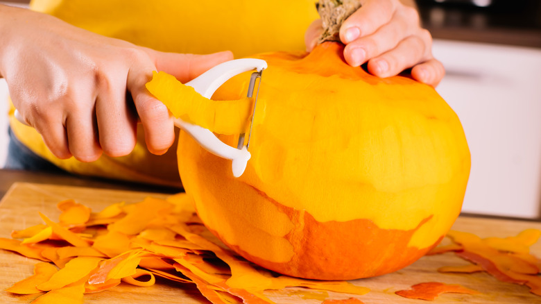 Woman peeling a pumpkin