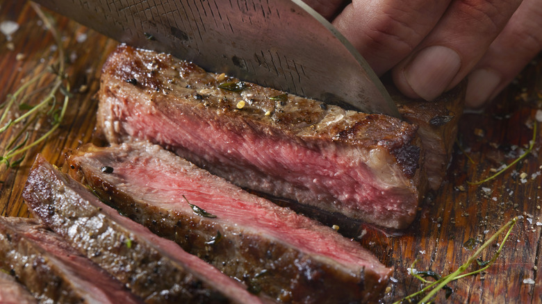 chef knife cutting steak