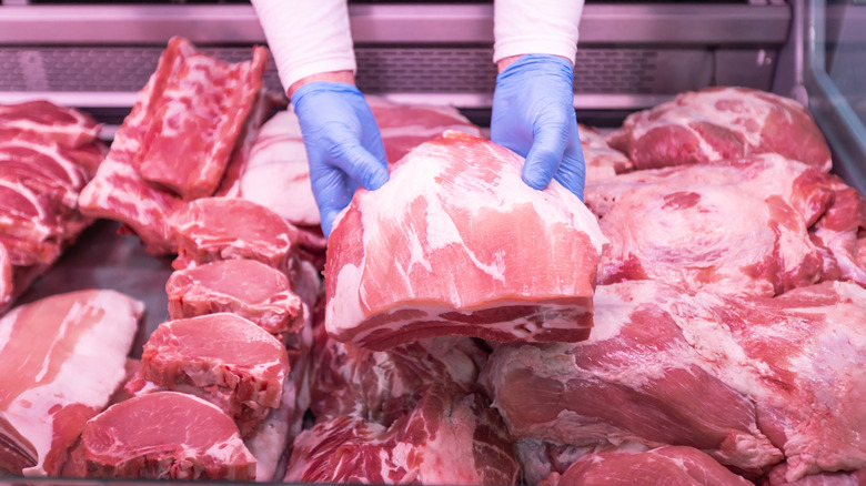 butcher presenting raw meat