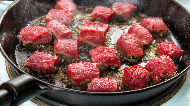 beef tips searing iron pan